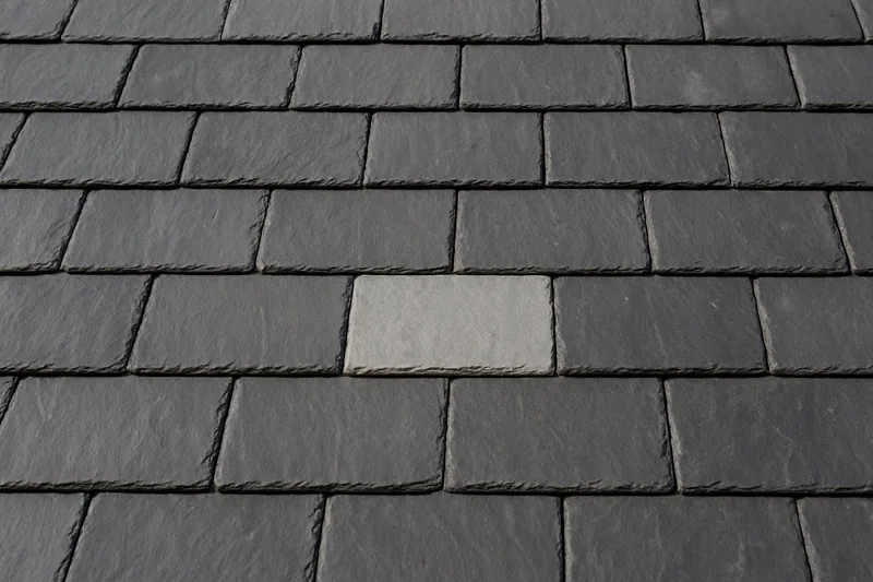 Overlapping grey slates in straight courses, one a shade lighter — slate roofing, Adelaide. Illustrative example.